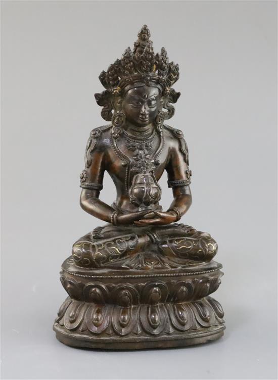 A Tibetan silver and gold inlaid copper alloy figure of Amitayus/Amitabha, c.15th century, H. 20.5cm